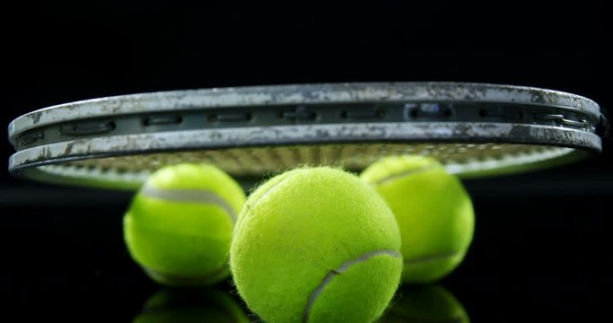Tennis balls and racket in studio 