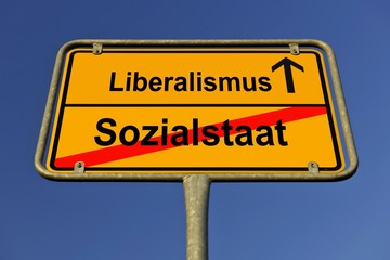 City limits sign with the words Liberalismus and Sozialstaat, German for liberalism and the welfare state, symbolic image for the end of the welfare state and the beginning of liberalism