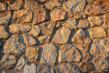 Fragment of sunlit stone wall