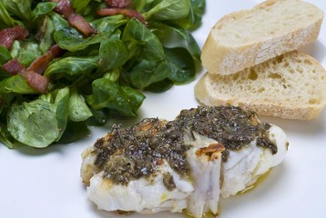 Sea-Devil fish (Lophius piscatorius) with with algae tartar and field salad (Valerianella locusta) with roasted bacon strips and baguette bread