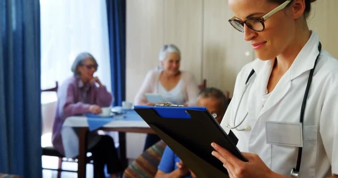 Portrait of female doctor reading reports 