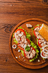 Delicious tuna sandwich, served with lettuce, tomato and onion.