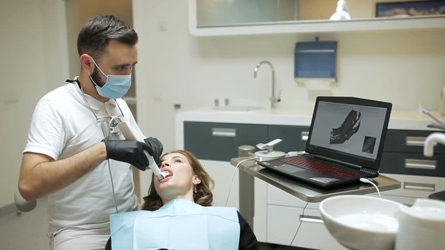 Dentist scanning the teeth of patient with a d scanner