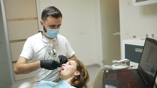 Dentist scanning the teeth of patient with a d scanner