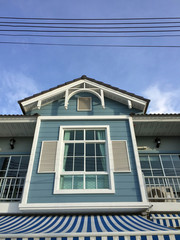 Townhouse viridian color and background blue sky. Out side of second floor green home on sunshine.
