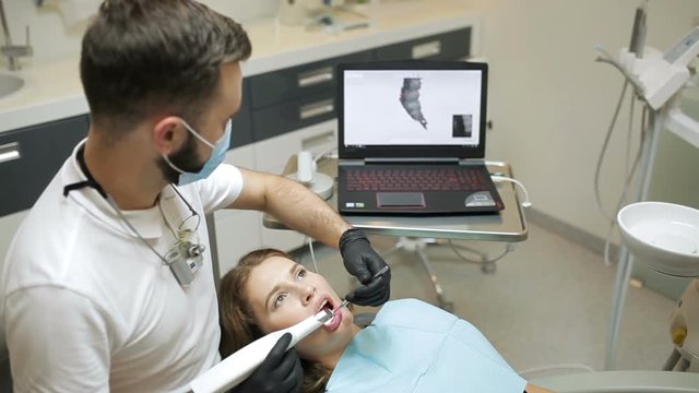 Dentist scanning the teeth of patient with a d scanner