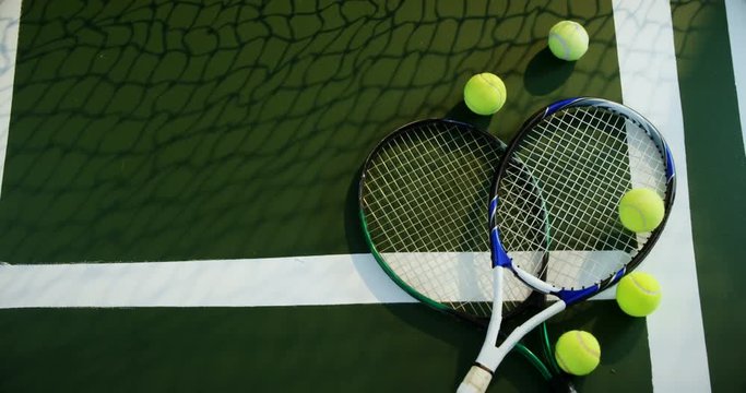 Racket and tennis ball in court 