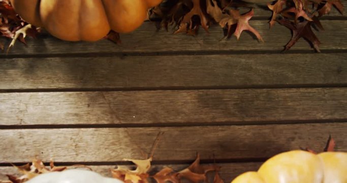 Halloween pumpkin with maple leaf on a wooden table  