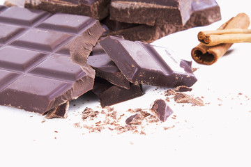 bar of chopped chocolate isolated on white