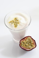 A glass of yogurt with a passionfruit