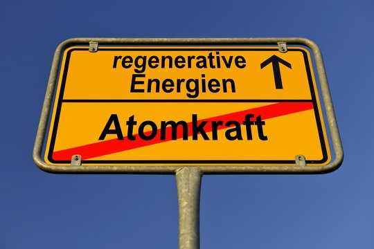 Symbolic image in the form of a town sign, in German, exit from atomic power, entrance into regenerative energy sources