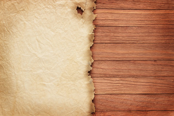 Crumpled papyrus on brown boards, vintage background