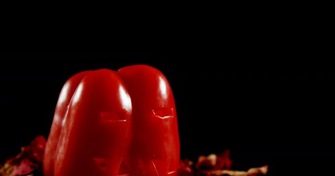 Halloween red pepper against black background 