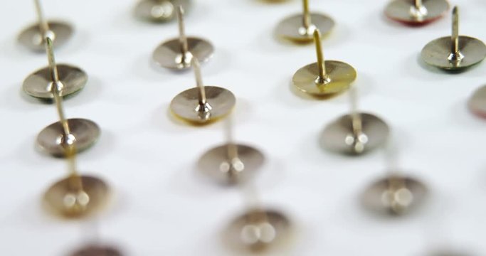 Golden push pin arranged on white background 