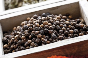 Black pepper, peppercorns in a spice box