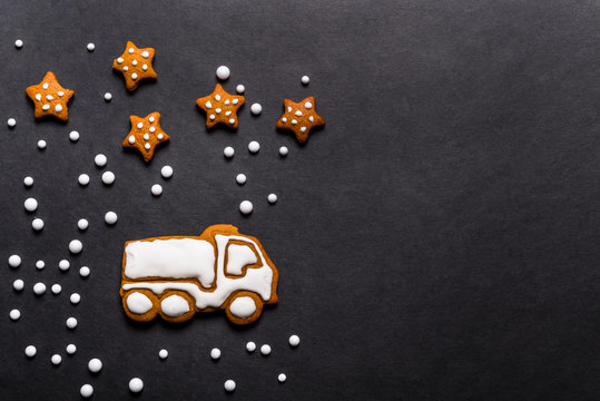Gingerbread cookies truck shaped on black background, Christmas concept