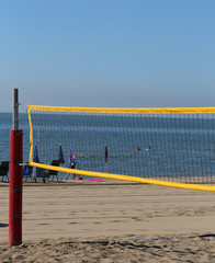 net to playing beach volley during summer vacation by the sea