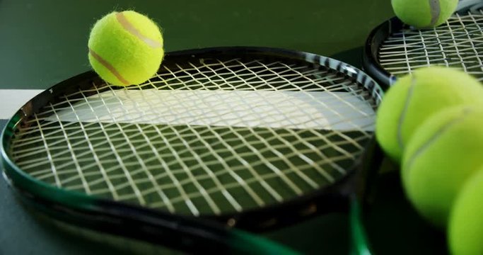 Racket and tennis ball in court 
