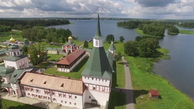 Valday Iversky Russian Orthodox Monastery. Valdaysky National Park UNESCO unique historical Biosphere Reserve Lake Seliger. Flight around aerial drone. Beautiful nature summer clouds horizon.