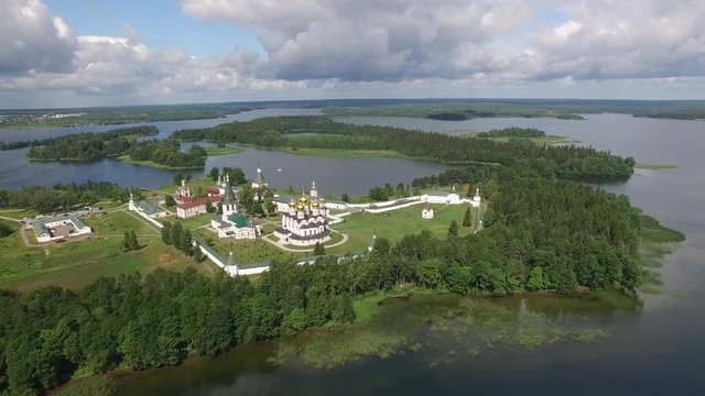 Valday Iversky Russian Orthodox Monastery. Valdaysky National Park UNESCO Biosphere Reserve Lake Seliger. Helicopter Flight around aerial. Beautiful nature summer spring clouds horizon blue sky.