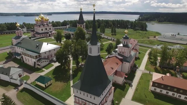 Valday Iversky Russian Orthodox Monastery spire. Valdaysky National Park UNESCO unique Biosphere Reserve Lake Seliger. Flight around aerial drone. Beautiful nature summer clouds horizon.