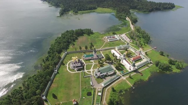 Valday Iversky Russian Orthodox Monastery wall. Valdaysky National Park UNESCO Biosphere Reserve Lake Seliger. Flight high altitude aerial drone. Beautiful nature summer clouds horizon.