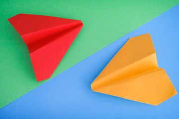 Yellow and Red Paper Planes on a Blue and Green Background