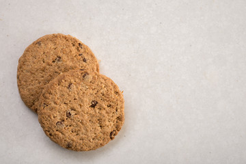 Brown chocolate biscuits isolated on the white marble background