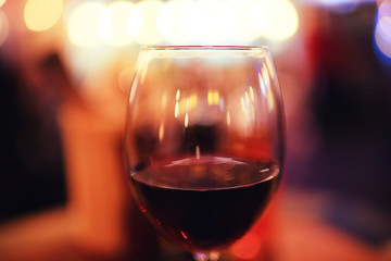 Serving a glass of red wine in a restaurant