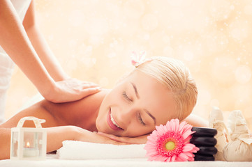 Obraz na płótnie Canvas beauty and spa concept - woman in spa salon getting massage