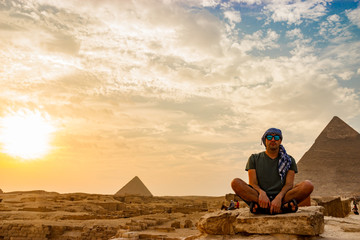 Naklejka na ściany i meble Meditation near the pyramids in Cairo, Egypt