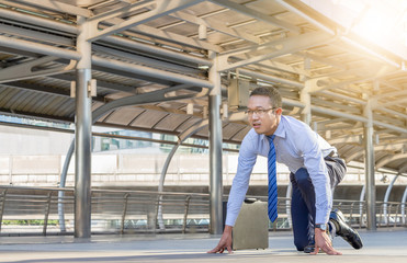 Fototapeta premium Business man in start position runner city background, Start for success concept.