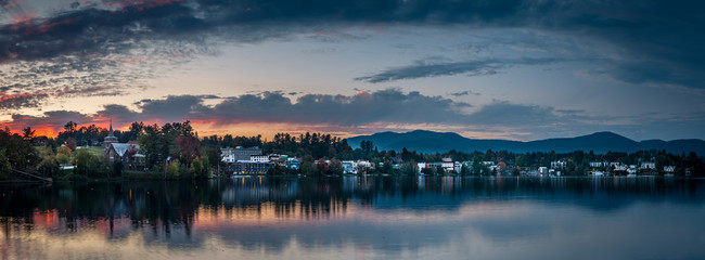 A panoramic view of the village of Lake Placid as seen from across Mirror Lake at sunset