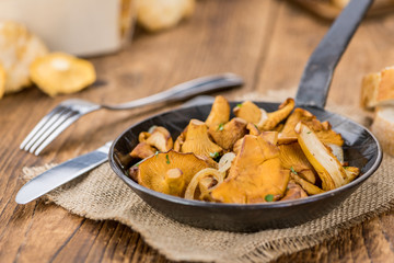 Fresh made Fried Chanterelles on a rustic background