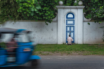 old man painting door in