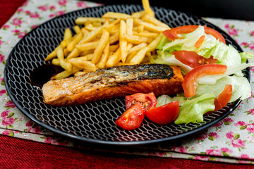 grilled salmon - french cuisine dish with tomato and salmon