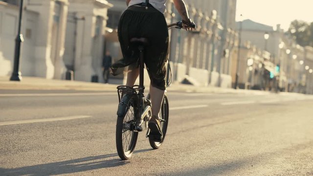 Ridding bicycle wheels close up. Woman bike city. Woman bike riding