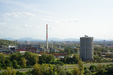 Fototapeta na wymiar Ostrava cityscape - industrial factory and city. Beskid mountains ( Beskids ) in the background. Industrial town in the Czech Republic, Czechia