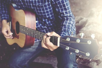 Acoustic guitar guitarist playing. Musical instrument with performer hands in parks.