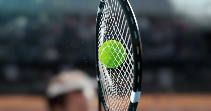 Tennis racket hit the tennis ball, in a super slow-motion, you see a deformation of the ball and small particles.