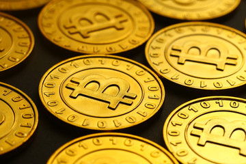 golden bitcoins tiled on black background