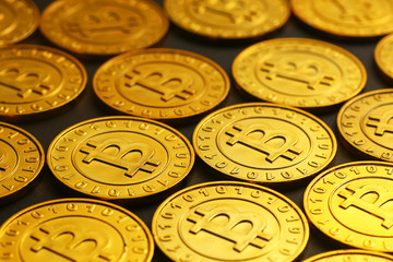 golden bitcoins tiled on black background