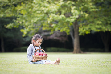 Little girl eating an apple