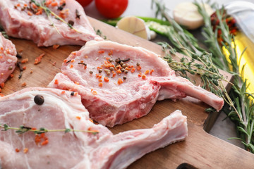 Wooden board with fresh raw meat, closeup