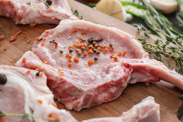 Wooden board with fresh raw meat, closeup