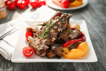 Plate with grilled ribs on table