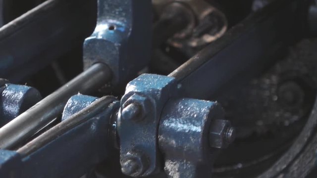Close shot of a steam powered engine piston in motion.