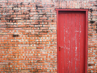 Vintage red door on brick wall