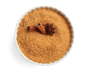 Bowl with cinnamon sugar and sticks on white background