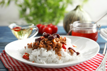 Chili con carne served with rice on dinner table